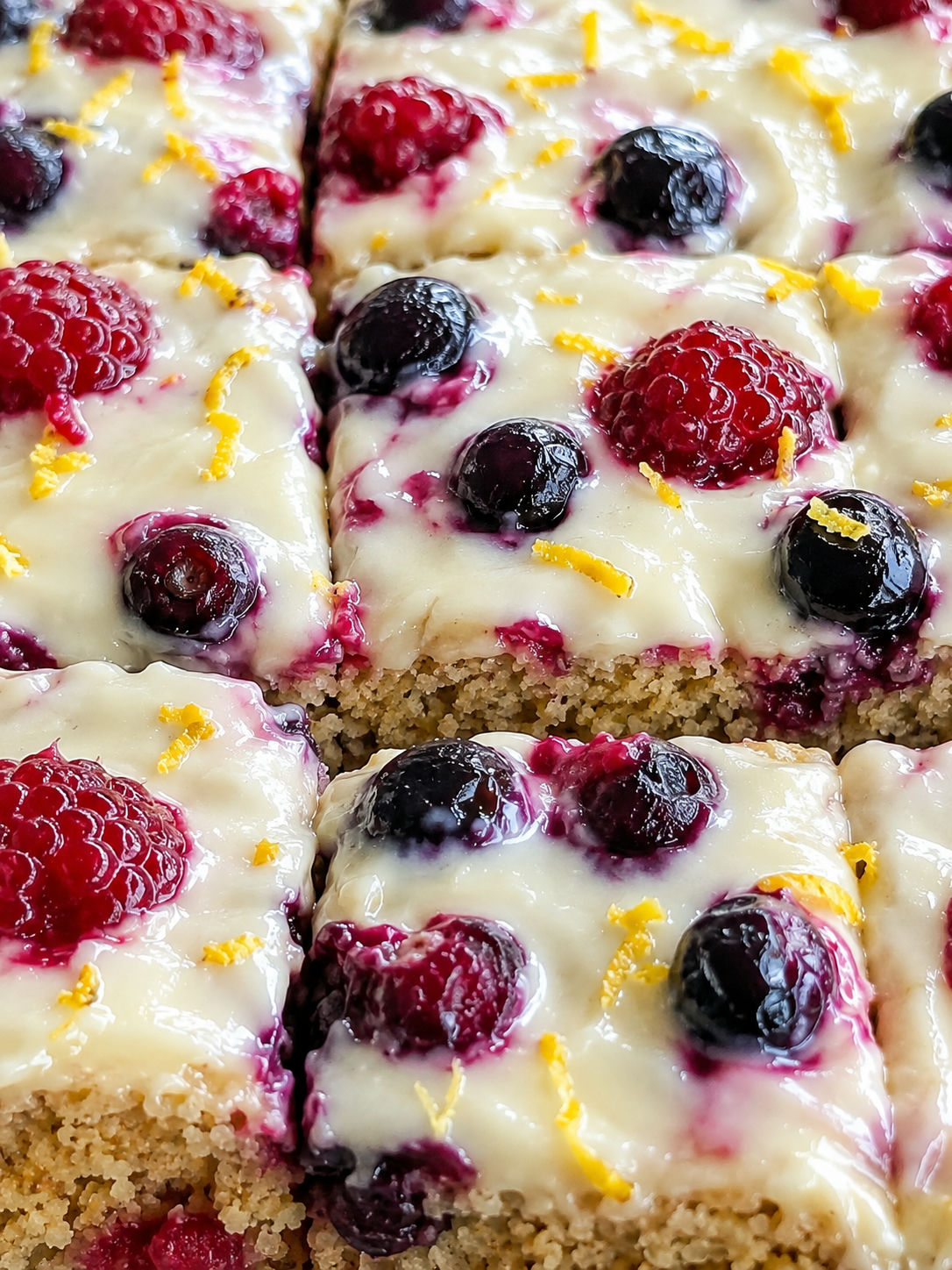Healthy oat yogurt berry cake slices with creamy topping