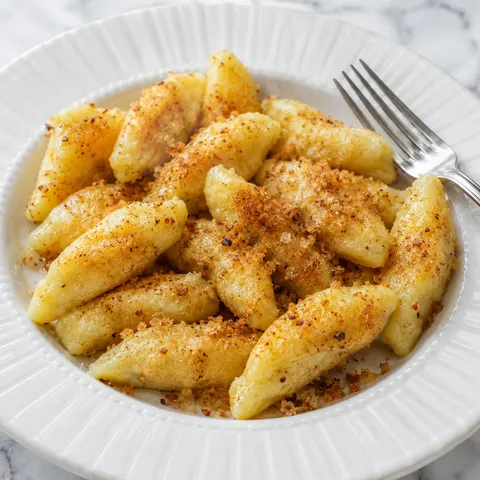 Golden Polish kopytka potato dumplings tossed in butter and toasted breadcrumbs