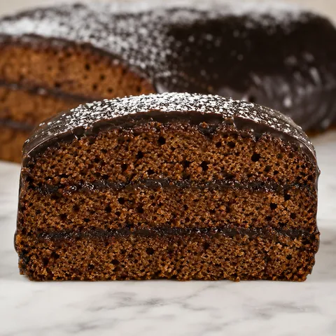 Slice of moist Polish spiced honey gingerbread cake with chocolate glaze